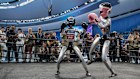 Humanoid robots fight during a kickboxing match at the World Humanoid Robot Games at National Speed Skating Oval in Beijing, China.