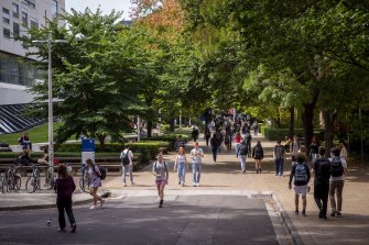 Students walk around the University of Melbourne.