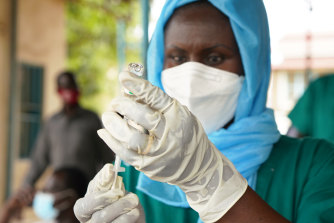 A healthcare worker prepares to administer a vaccine in South Sudan through the World Health Organisation’s COVAX scheme.
