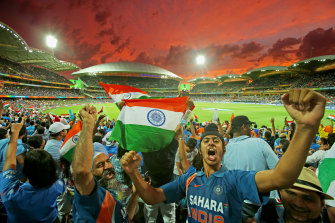 Indian fans celebrate as a Pakistan wicket falls in a 2015 Cricket World Cup match at the Adelaide Oval.