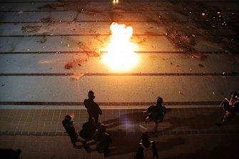 Protesters practice throwing molotov cocktails into a swimming pool at Hong Kong Polytechnic University.