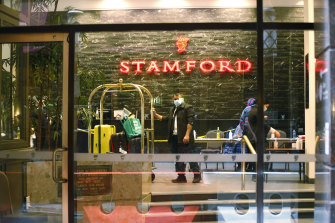 Hotel workers inside the Stamford Plaza, one of the quarantine hotels that became the site of an outbreak last year.