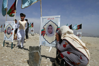 A mother weeps at her daughter’s grave on the outskirts of Kabul. An estimated 150,000 Afghans have died in the 20-year war. 