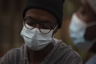 A student from the Tshwane University of Technology wears a face mask outside his residence in Pretoria, South Africa.