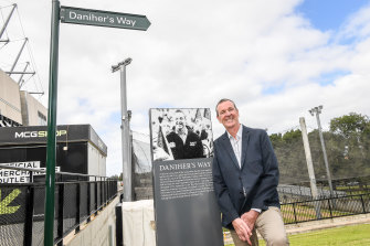 Neale Daniher poses next to the sign marking Daniher's Way.