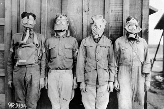 Men modelling gas masks used in World War I by (from left) American, British, French and German forces.