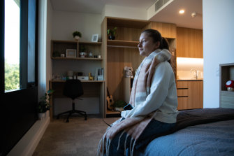 Elise Magnus in a display bedroom at the new student accommodation at Macquarie University by Luke Johnson of Architectus.