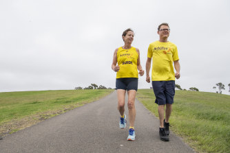 Blind runner Tom Zell and his running partner Cindy Skacel preparing for Sunday’s race.