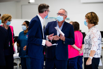 Premier Dominic Perrottet, Health Minister Brad Hazzard and NSW Health Deputy Secretary Susan Pearce at the opening of the Granville Centre vaccination clinic in western Sydney on Sunday.