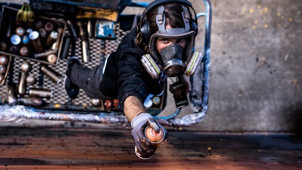 Mural artist Adnate at work.