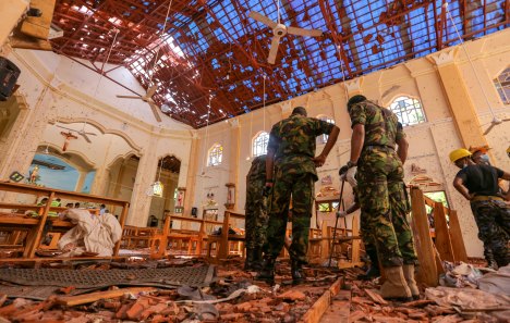 Soldiers inspect the damage inside St. Sebastian's Church in Negombo, Sri Lanka.