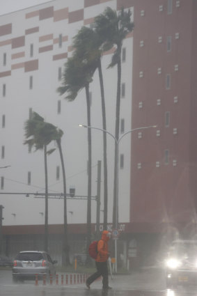 A person makes their way through the rain in Miyazaki, southern Japan, on Sunday.