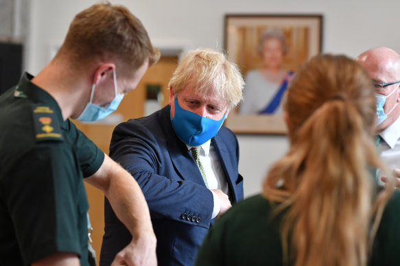 Boris Johnson, seen here visiting paramedics, is expected to announce a ban on Huawei equipment in Britain's 5G networks.