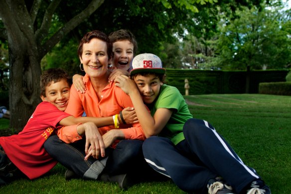 Kay Olo, left, with his mum Kirsty Sword Gusmao and siblings Alex, right, and Daniel in 2013.