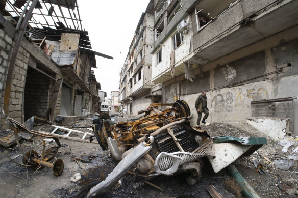 A man walks in the courtyard of an apartment building damaged by Azerbaijan shelling in Stepanakert, self-proclaimed Republic of Nagorno-Karabakh, on Wednesday.