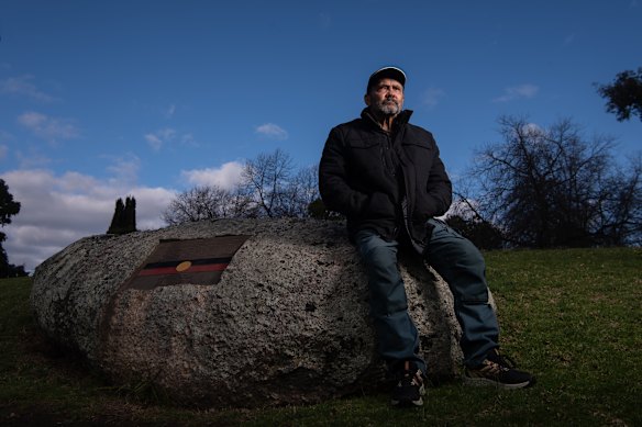 Aboriginal elder Uncle Robbie Thorpe at the granite rock that marks the burial ground of 38 First Nations people.