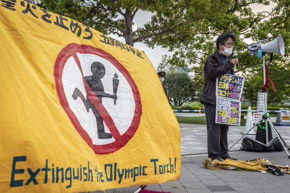 A protester speaks during a protest against the Tokyo Olympics, where concerns lingers over the feasibility of hosting the event amid a pandemic. 
