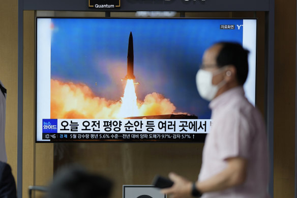 A TV screen in Seoul shows a news program reporting on a North Korean missile launch in June.