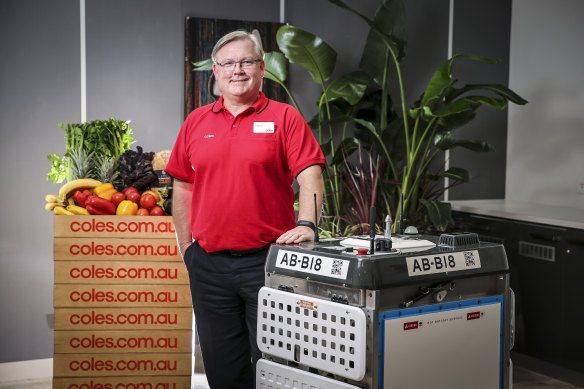 Coles chief Steven Cain with one of the "daleks" that will pick online grocery orders. 