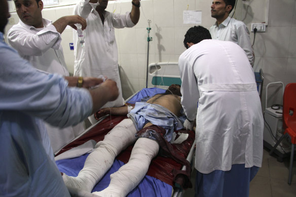 A wounded man receives treatment at a hospital after a suicide car bomb and attack by multiple gunmen in Jalalabad, east of Kabul, on Sunday.
