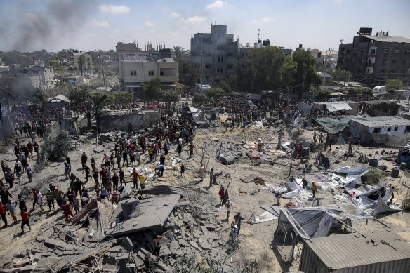 Palestinians at the bombed site, which is in an area marked safe by the IDF.