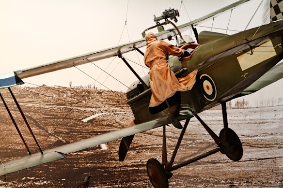 Drama in the skies … daredevil flying ace Keith Caldwell steers his plane from a wing.