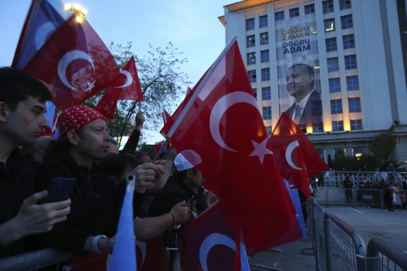 Supporters of Turkish President Recep Tayyip Erdogan’s ruling party gather at the party headquarters, in Ankara on Sunday. 