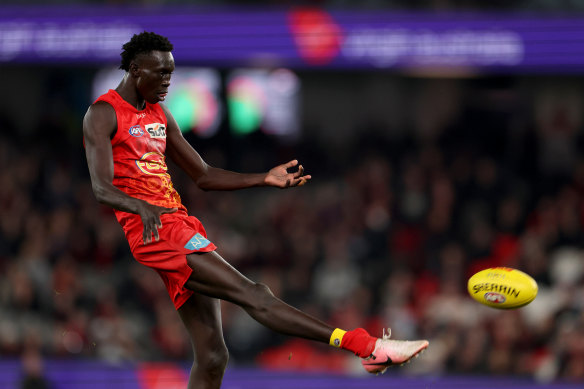 Mac Andrew of the Suns kicks the winning goal after the siren.