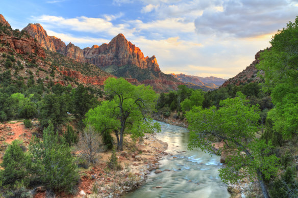 The day’s last rays of sun catch The Watchman in Zion National Park, Utah.