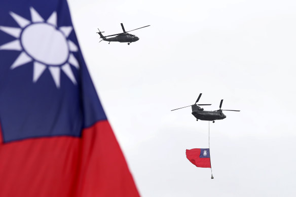 Helicopters fly over President Office with Taiwan National flag during the National Day celebrations in Taipei, Taiwan, on Saturday.