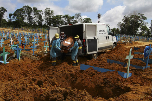 Cemetery workers carry the coffin of 89-year-old Abilio Ribeiro, who died of COVID-19, at a cemetery in Manaus, Brazil this month.