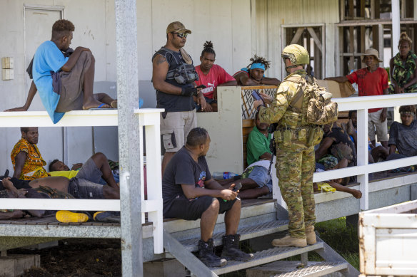 An Australian soldier talks to locals during a community engagement patrol in Honiara in November last year.
