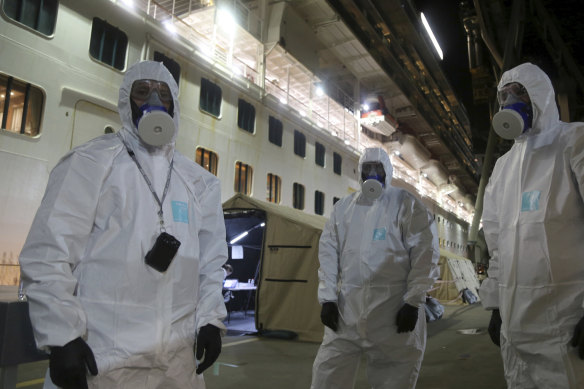 In Wollongong, NSW Police officers prepare to board the Ruby Princess cruise ship to seize evidence in what is now a criminal and coronial investigation. 