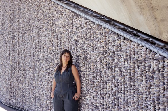 Artist Megan Cope with part of her monumental installation.