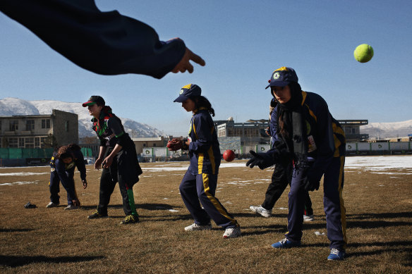 The Afghan women’s cricket team trains on a snow-covered Kabul Cricket Stadium.