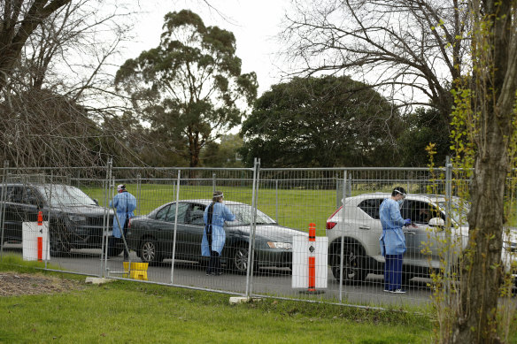 Cars lining up at a testing site at Albert Park on Monday. Some testing sites have started turning people away as they reach capacity.
