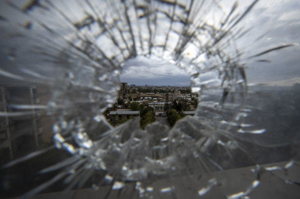 The city of Mekele is seen through a bullet hole in a stairway window of the Ayder Referral Hospital in the Tigray region of northern Ethiopia in May last year.
