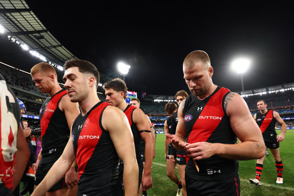 The Bombers look dejected as they leave the field following their loss. 