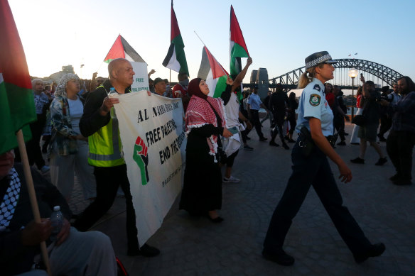Palestine supporters rallying outside the Sydney Opera House under police supervision.