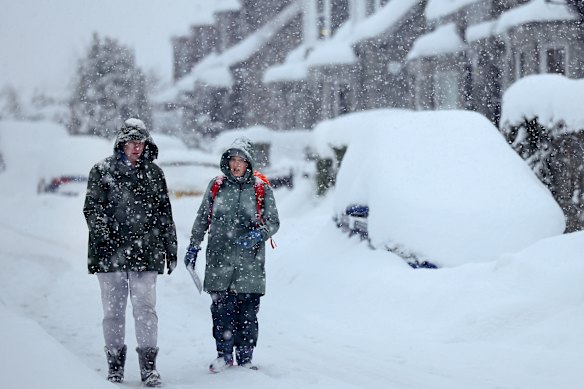 People walk through Alford, near Aberdeen in Scotland, on Tuesday.