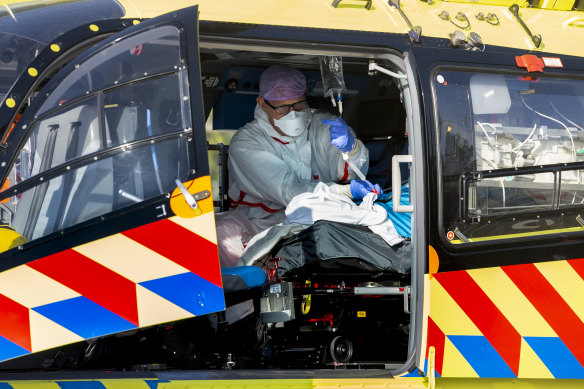 A COVID-19 patient is flown from the Netherlands, where hospitals have been swamped with virus patients, to Germany for treatment.