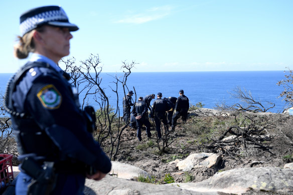 Police undertake a search at North Head near Manly on Tuesday following an arrest.