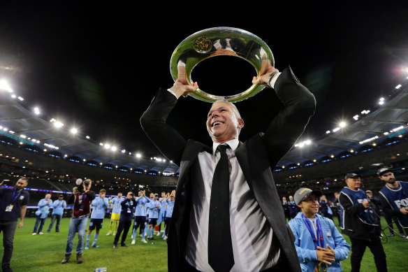 Sydney FC coach Steve Corica with the trophy after winning last season's A-League grand final.