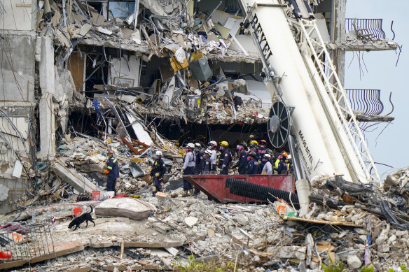 Crews work in the rubble of Champlain Towers South in Surfside on Tuesday.