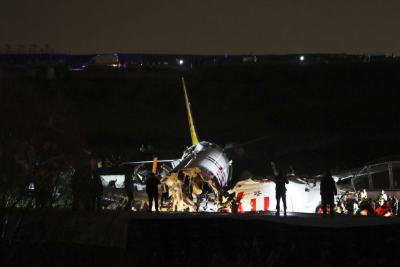 Emergency workers at the site of the crash at Sabiha Gokcen Airport.