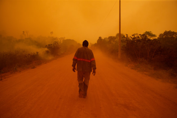 A volunteer firefighter walks along Transpantaneira road at the Pantanal wetlands region in Porto Jofre city, Mato Grosso state.