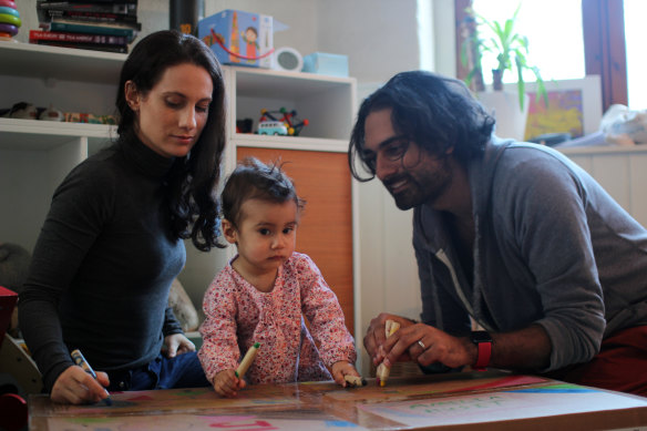 Ketan Joshi, right, and his wife Kim play with their daughter Amelia in home quarantine in Oslo, Norway. 