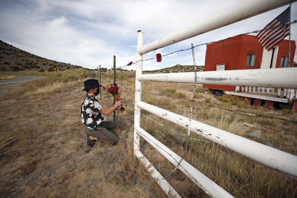 A woman, who did not want to give her name, places a flower bouquet at the entrance of the Bonanza Creek Film Ranch in Santa Fe where cinematographer Halyna Hutchins was shot.