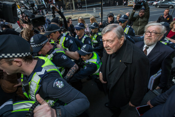 George Pell and barrister Robert Richter arrive at court under police guard in Melbourne in 2017.
