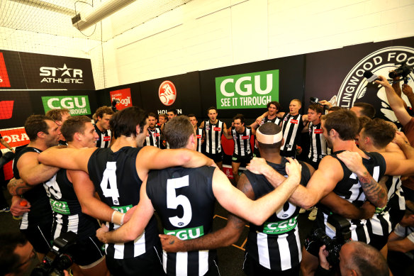 Collingwood players celebrate after the game.